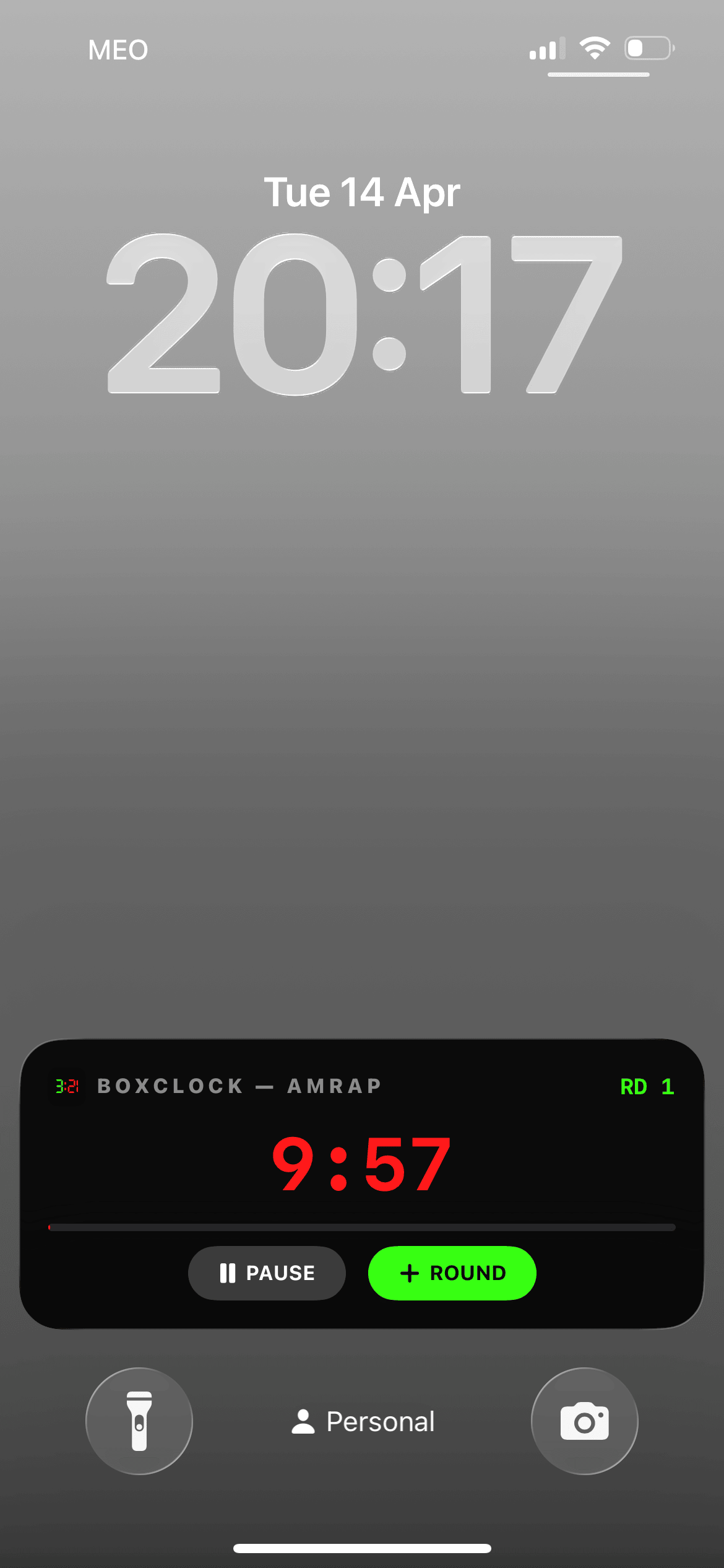 BoxClock AMRAP Live Activity showing timer and round button on iPhone lock screen